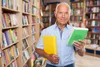 man holding two books