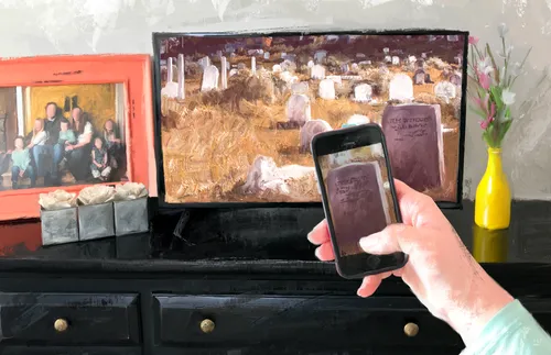 hand holding a phone in front of television