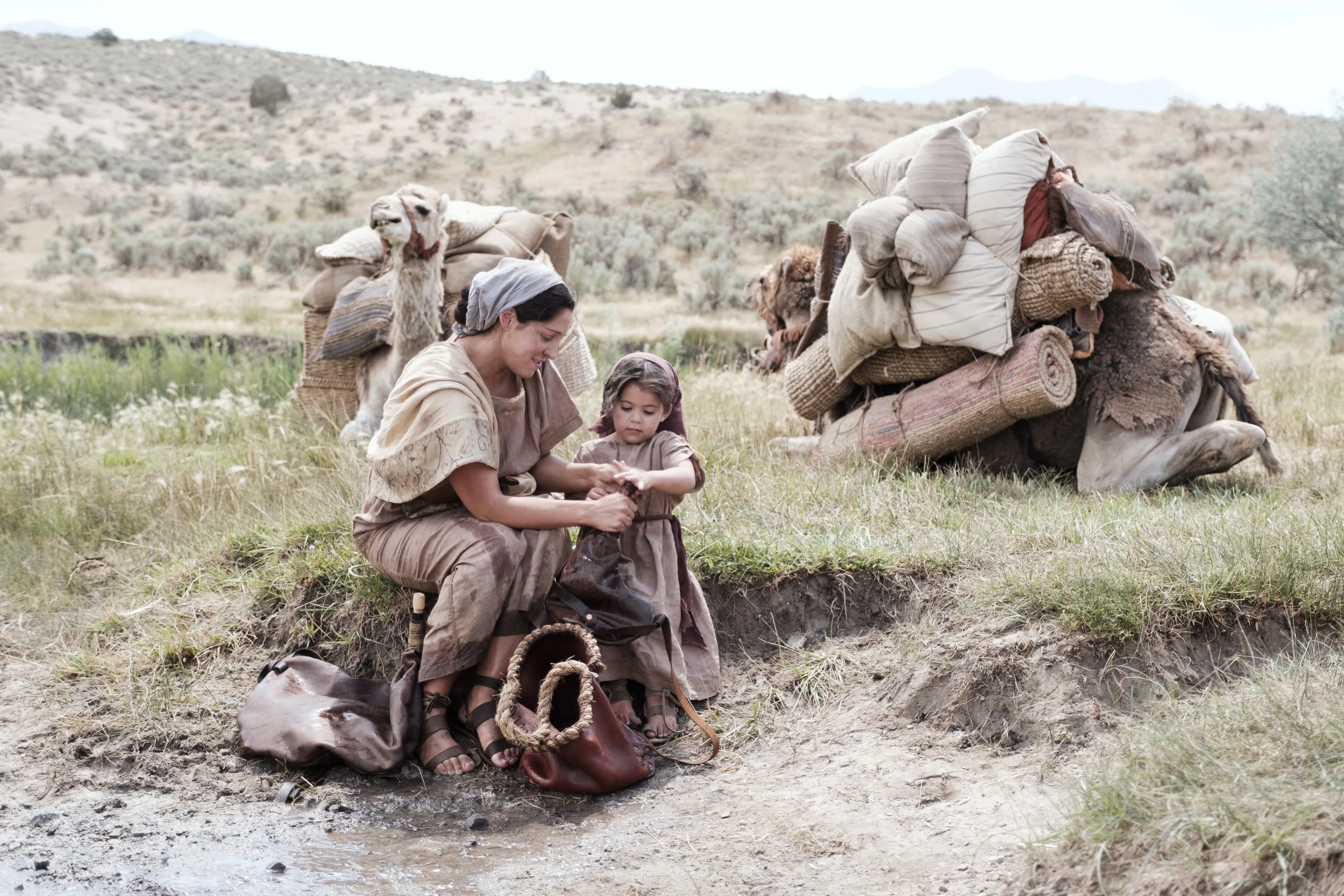 One of Ishmael's daughters and child gather water in the wilderness.