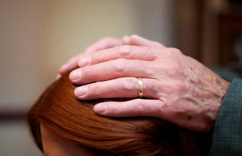 hands lying on top of a head