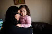 A mother grieves with her young daughter