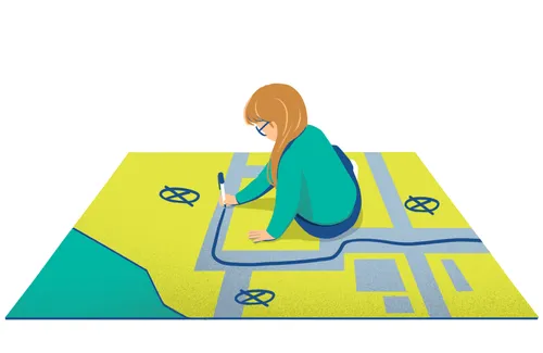 young woman drawing on a large map she is sitting on