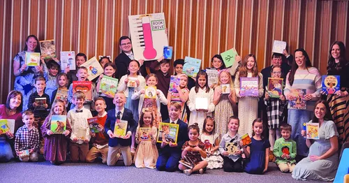Group of Primary children holding books