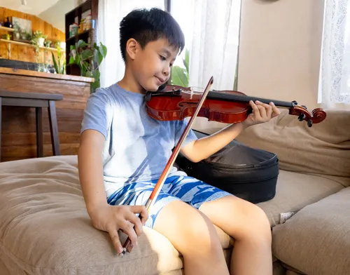 Photo of Adam playing the violin