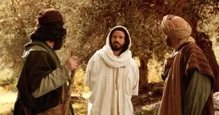 Jesus talks to two disciples on the road to Emmaus