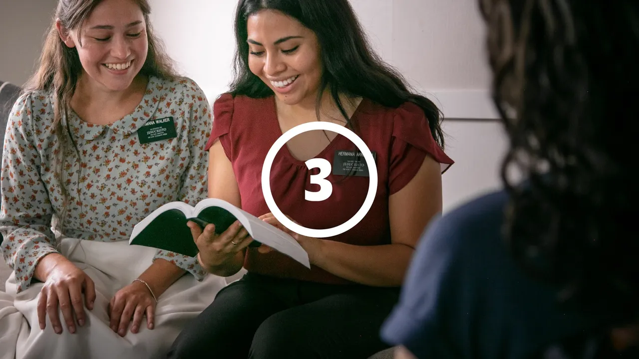 Missionaries reading to a woman from the Book of Mormon