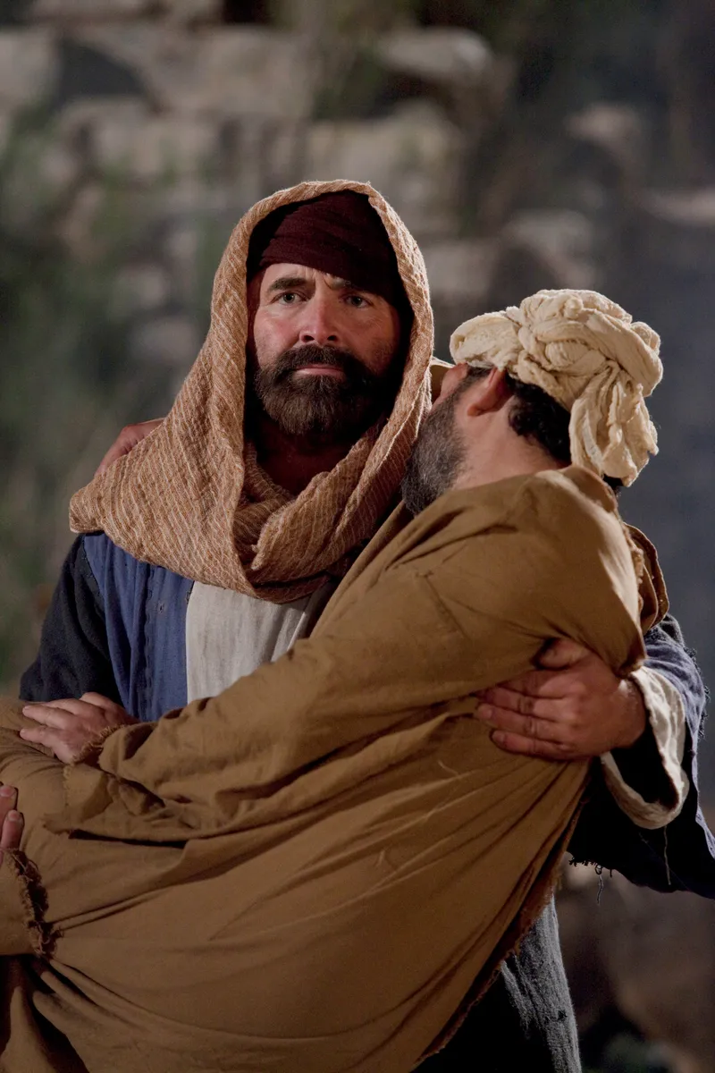 The good Samaritan bringing an injured man he found to an inn