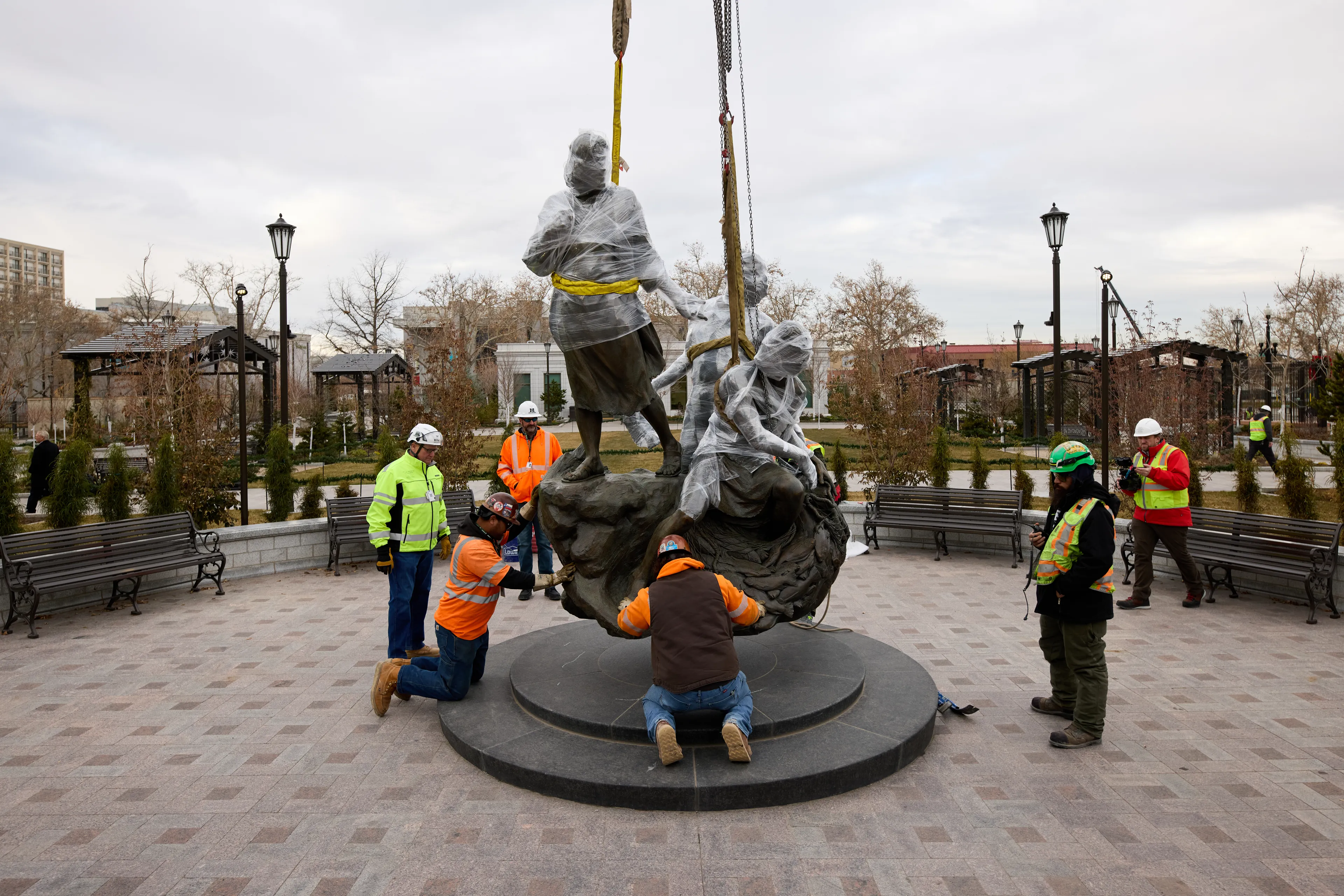 A view of Temple Square while under construction in December 2024. The image features the Come Follow Me Statue being lowered into place at the northwest quadrant next to the Salt Lake Tabernacle. © undefined ipCode 1.