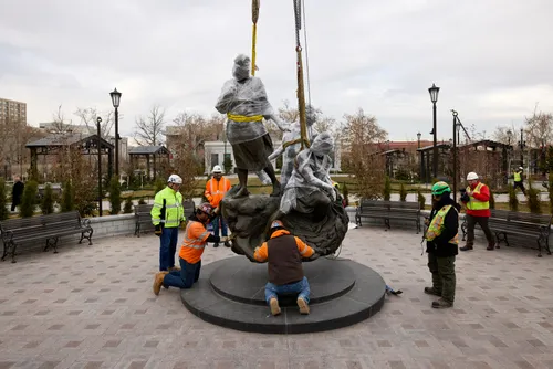 A view of Temple Square while under construction in December 2024. The image features the Come Follow Me Statue being lowered into place at the northwest quadrant next to the Salt Lake Tabernacle. Do Not Copy.