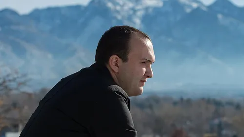 man looking at mountains