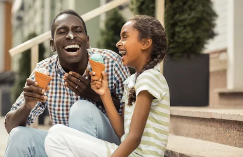 father and daughter eating ice cream cones