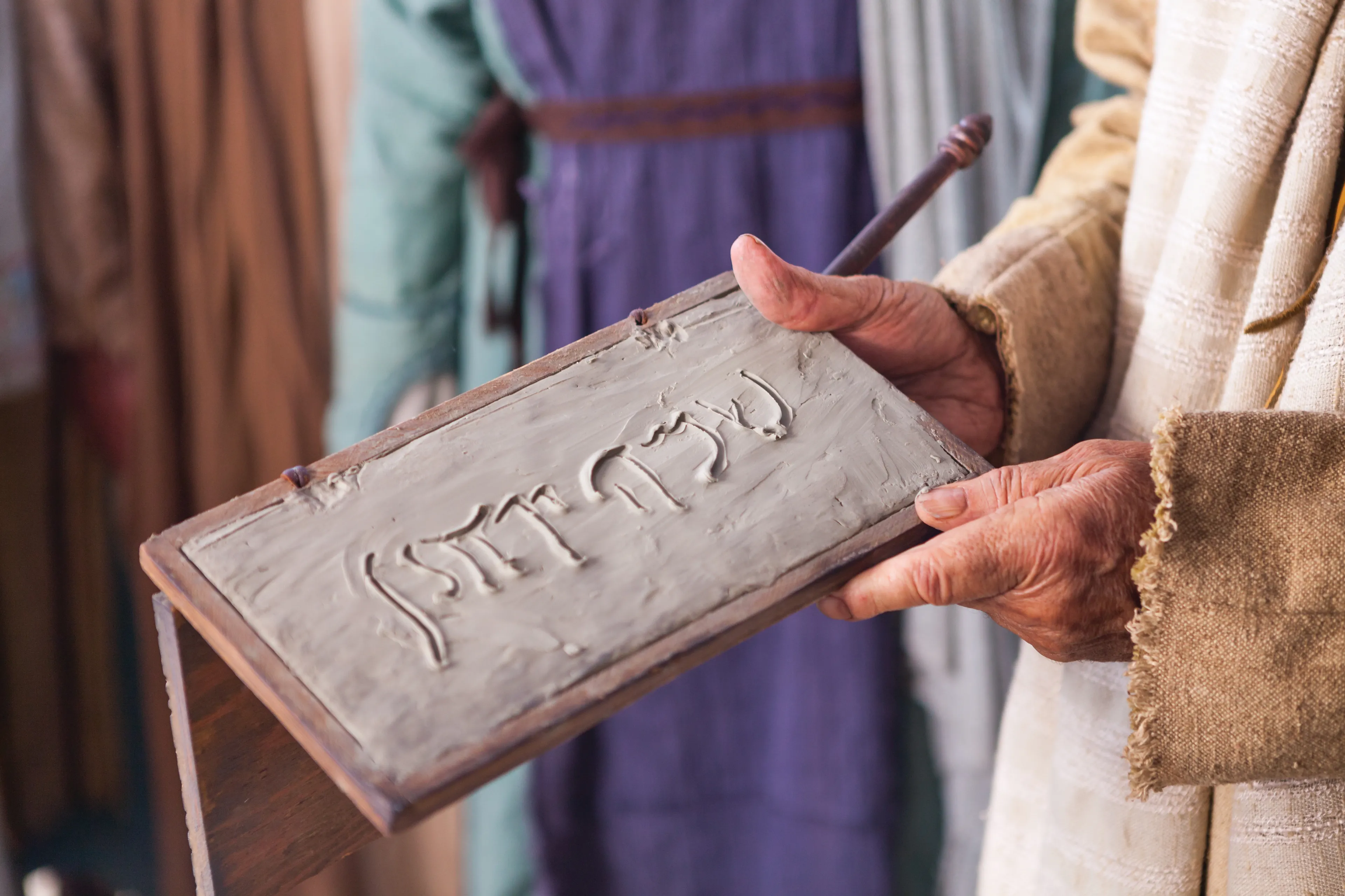 The name of John is written on a tablet.