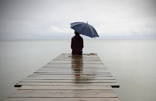 person sitting on pier