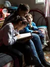 mother studying scriptures with children