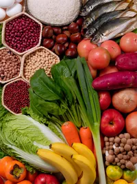Close-up photograph of various fruits, vegetables and other foods.