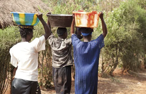 women holding water buckets over there head