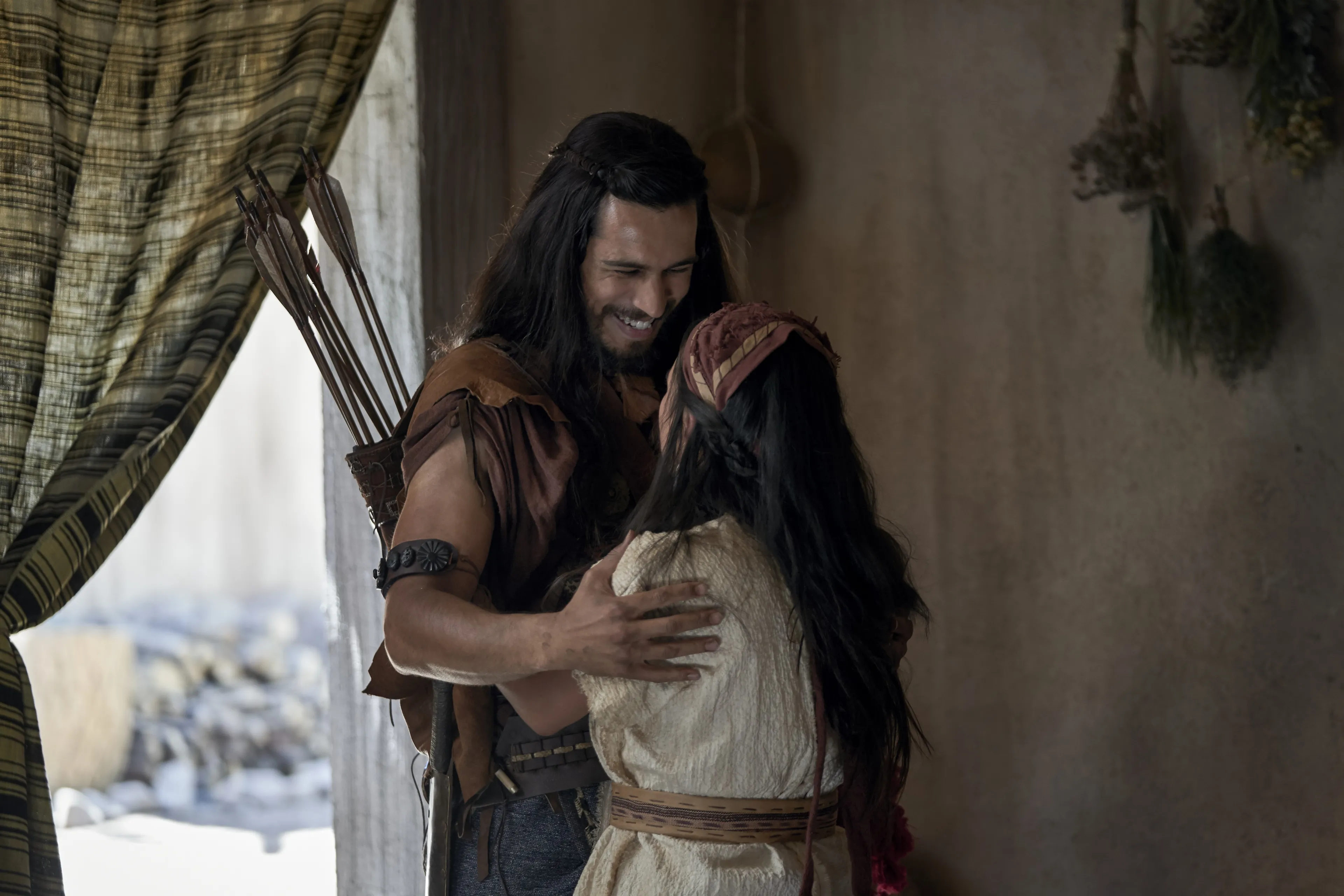 Enos greets his wife in their home.