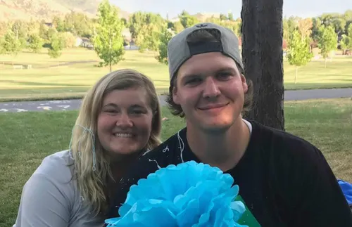 young couple sitting outside on the grass