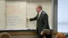 man in front of whiteboard