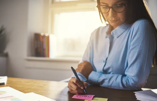 woman writing at desk