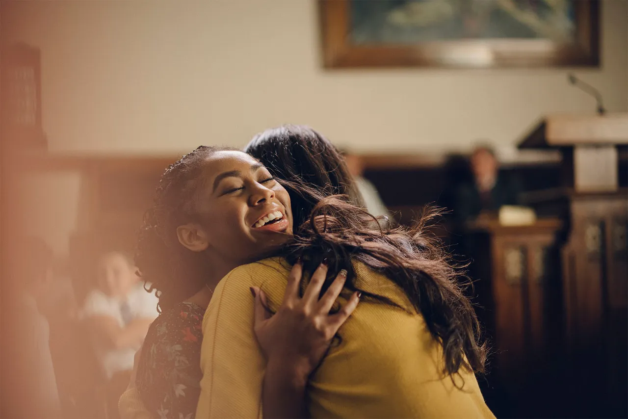 Two women hug at church