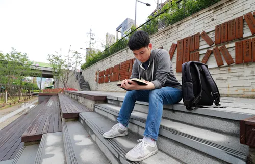 young man reading and pondering the scriptures
