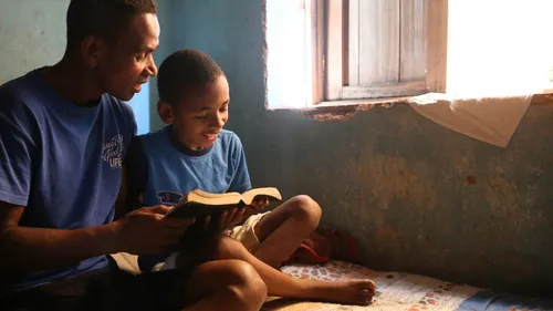 father reading to child