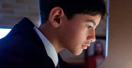 young man looking at computer screen