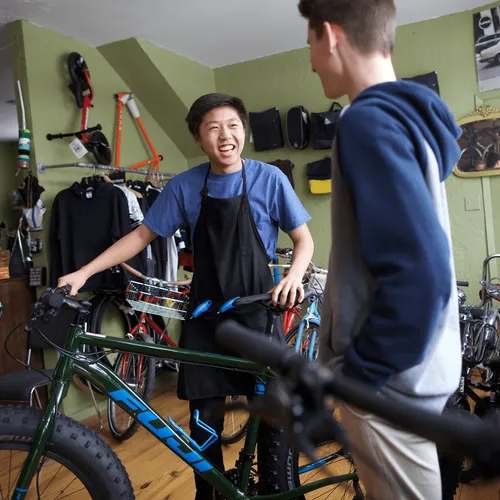 young men in a bicycle shop