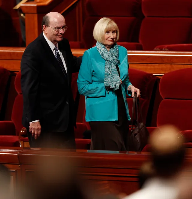 Elder Quentin L. Cook and his wife walk together after a session of conference.