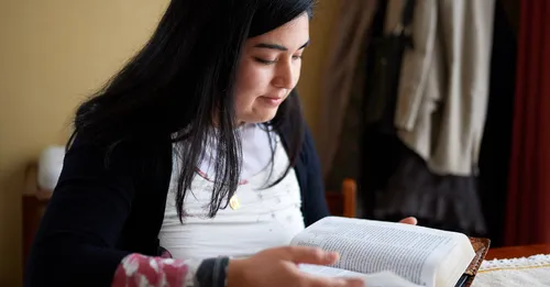 A girl reading scriptures.
