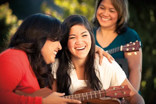 young women playing ukelele