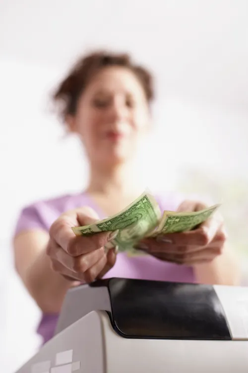 hands holding dollar bills