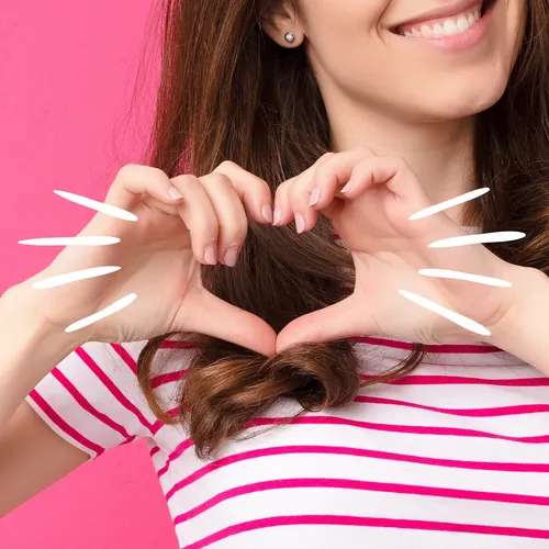 young woman with hands in heart shape