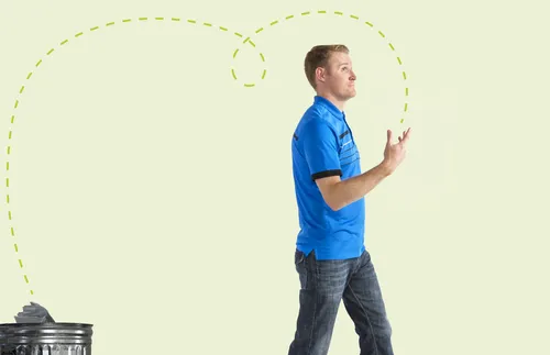 man tossing magazine away