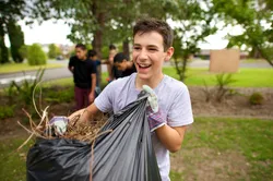 Young man with bag of leaves