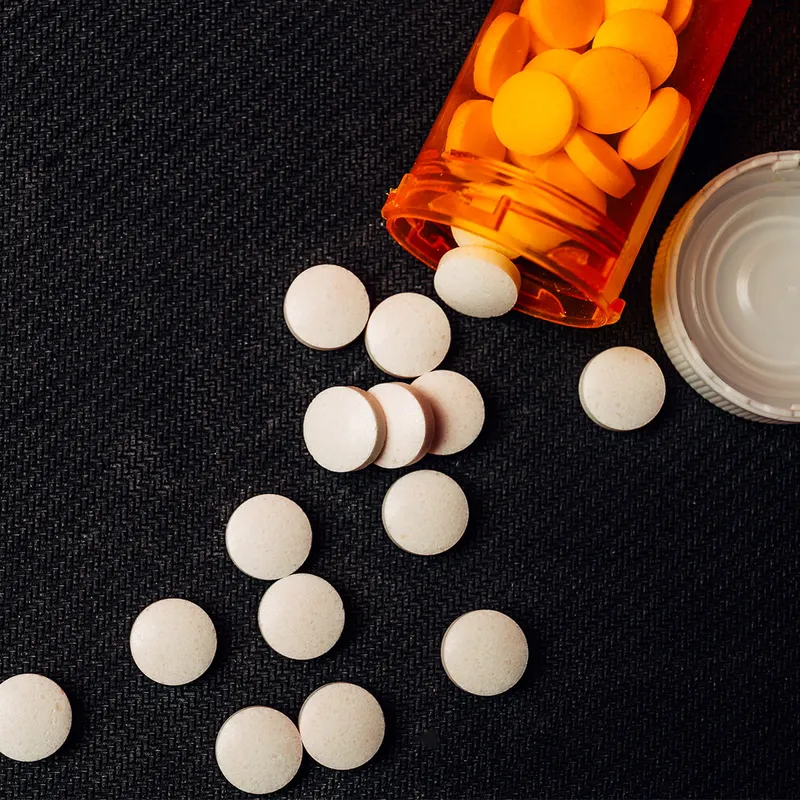 A bottle of pills spilled out on a table saying don't use illegal drugs as part of the word of wisdom