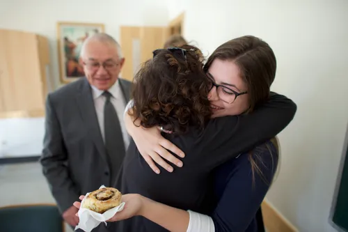 Woman hugging younger woman