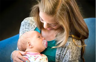 young woman holding newborn