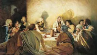 Jesus Christ seated at a table with His apostles. The apostles are watching Christ as He breaks bread and offers it to them in remembrance of His body and blood. The painting depicts the institution of the Sacrament at the Last Supper.