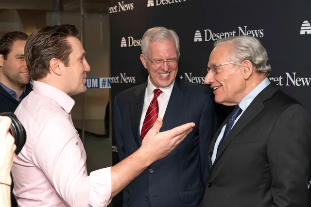 A guest visits with Elder D. Todd Christofferson of The Church of Jesus Christ of Latter-day Saints (middle) and Bob Woodward, associate editor of the Washington Post, at a reception prior to a forum on integrity and trust held at the Newseum in Washington, D.C., January 14, 2019.
