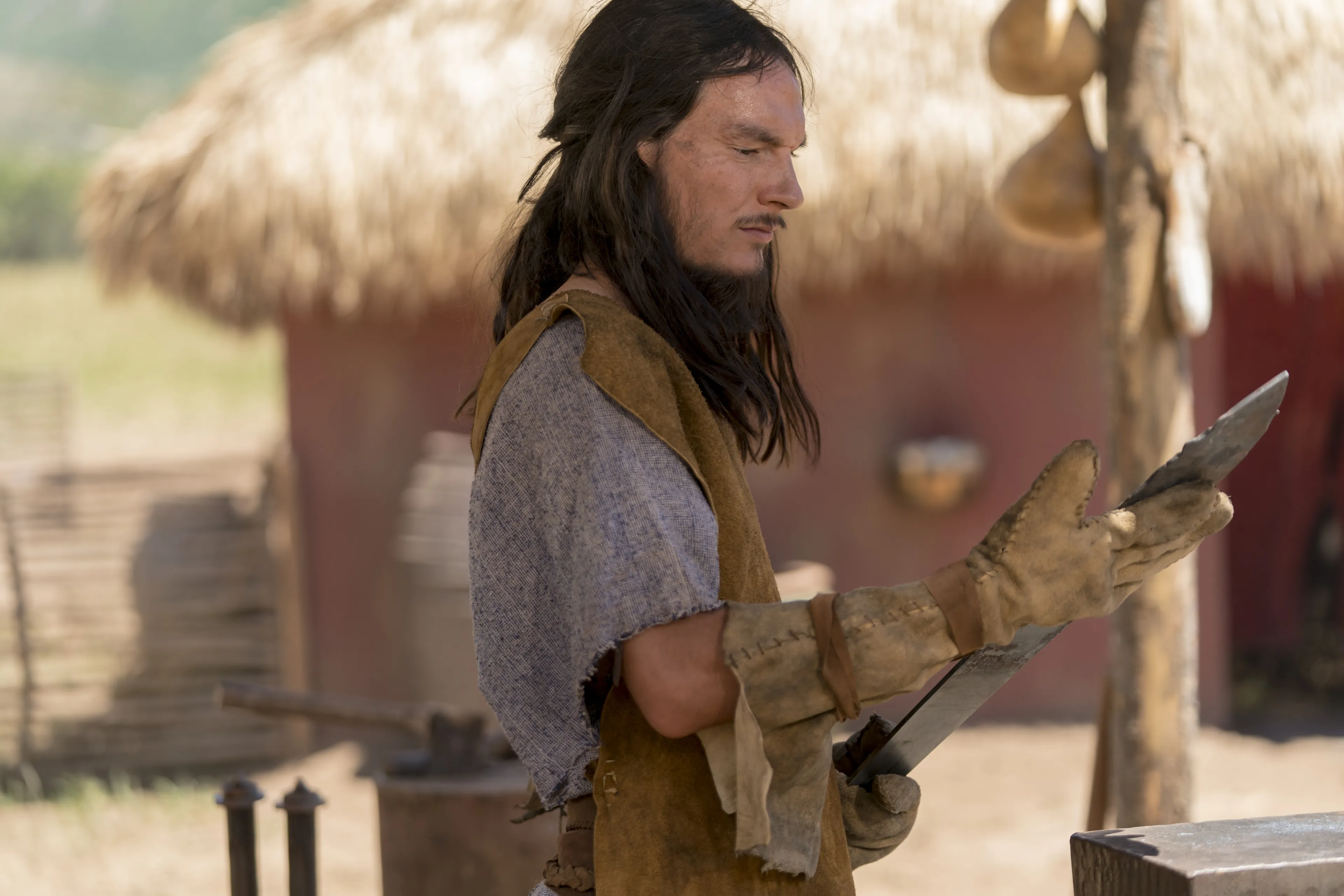 Sam inspects a sword.