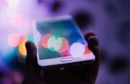 A hand holding a cell phone