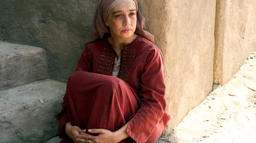 a woman with an issue of blood sitting on the ground