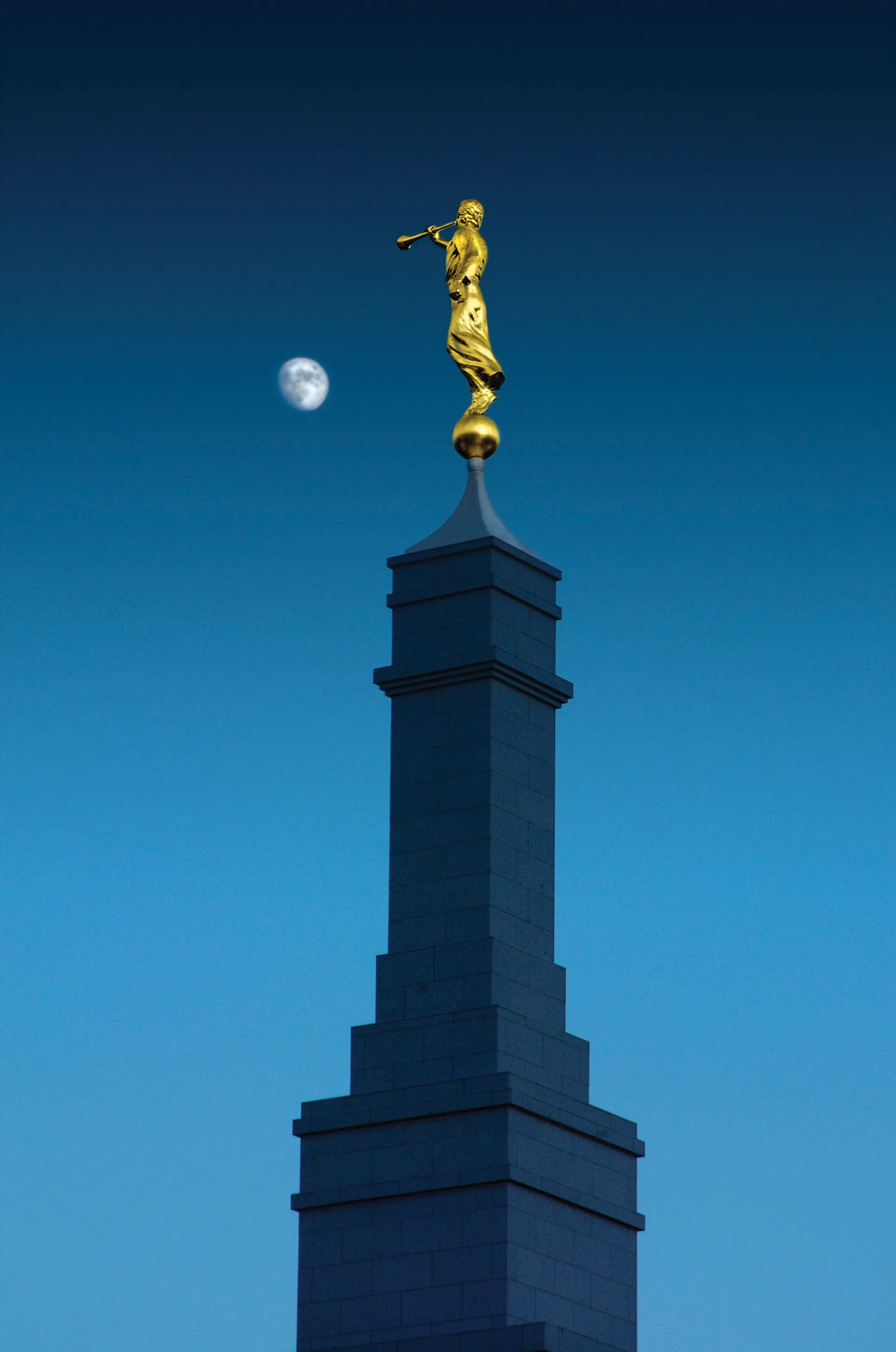 A view of the spire of the Fresno California Temple at night, with the angel Moroni on top.