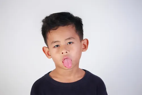 Little boy sticking out tongue