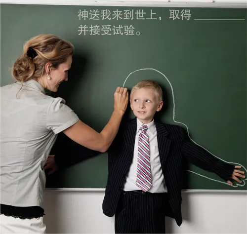 teacher tracing outline of child on chalkboard