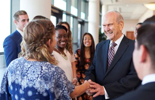 President Nelson surrounded by young adults