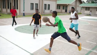Series of images of young men and adult males playing sports basketball and soccer in Congo