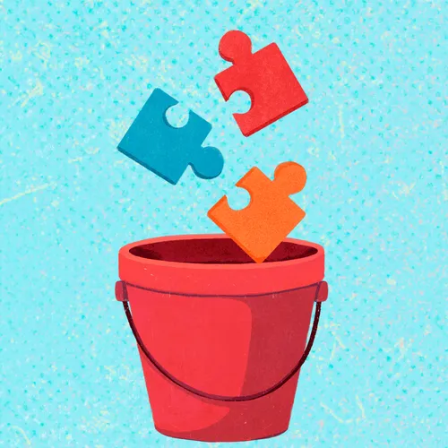 puzzle pieces falling into a bucket
